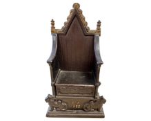 A cast iron money box 'The Imperial Throne', height 21 cm.