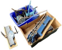 Two boxes containing mitre saws, drill stands, a car jack etc.