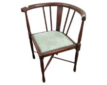 An Edwardian corner armchair.