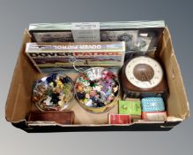 A box containing playing cards, board games, miniature ornaments including glass examples,