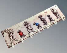 A cast iron dog seven hook coat rack.