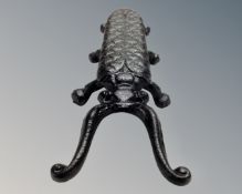 A cast iron scarab boot jack.
