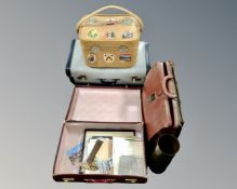 A brass ammunition shell together with four vintage cases, one containing paper ephemera,