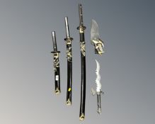 A set of three graduated Japanese style katanas together with two further fantasy knives,