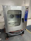 A stainless steel commercial steam oven on trolley stand.