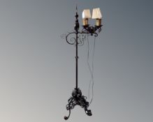 A 20th century wrought iron rise and fall standard lamp.
