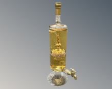 A novelty bottle of Highland malt scotch whisky in the shape of a tall carafe with decanting tap