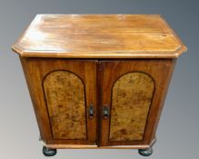 A 19th century walnut double door low cabinet on bun feet.