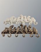 Two cast iron cat six hook coat racks.