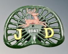 A cast iron John Deere tractor seat.