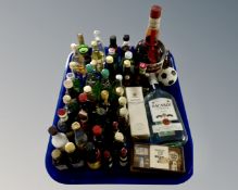 A tray containing assorted alcohol including a bottle of Grand Marnier, Bacardi,
