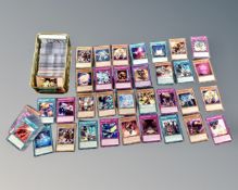 A Yu-Gi-Oh tin containing a large quantity of trading cards.