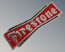 An aluminium Firestone wall plaque.