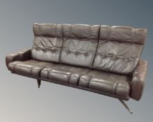 A 1970s Scandinavian three piece lounge suite comprising of a three seater settee,