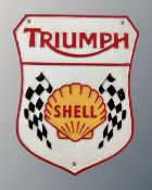 A cast iron Triumph Shell wall plaque.