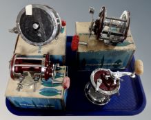 Four Penn fishing reels including Super Peer 309, Beach Master 160,