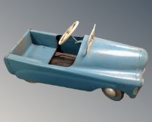 A mid-20th century tin plate pedal car.