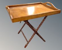 An oversized butler's tray on bobbin turned folding stand.