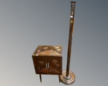 An eastern carved hardwood standard lamp together with a similar double door cabinet on raised legs.