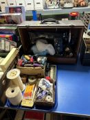 A cased vintage Singer sewing machine together with a tray containing sewing equipment.