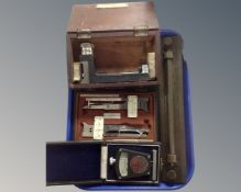A tray containing a vintage brass slide rule, a T. C.