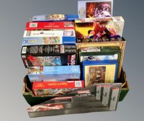 A box containing assorted boxed jigsaws together with a Powerfix tri square set.