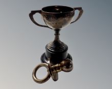 A Birmingham silver trophy on stand together with a silver dummy.