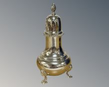 A silver sifter, retailed by Harrods, 1957 London hallmarks, height 15cm.