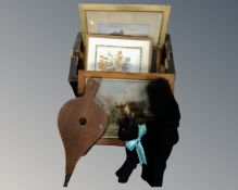 A box containing antiquarian pictures, wooden bellows a vintage straw filled soft toy of a cat.