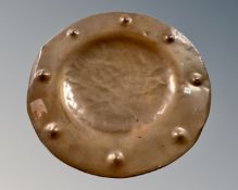 A hammered copper charger.
