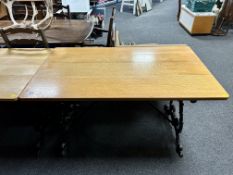 An oak topped rectangular bar table on cast iron legs.
