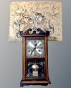 A Highland 31 day mantel clock and a 20th century continental school oil on canvas