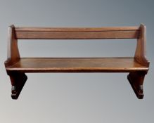 A pitch pine pew, length 155 cm.