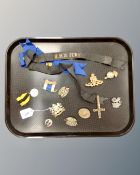 A Manchester regiment badge, together with further military badges, HMS Fury ribbon,