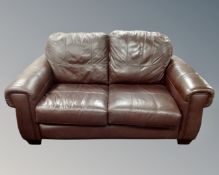 A contemporary brown leather two seater settee