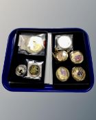 Two coin boxes containing a collection of seven commemorative struck coins, some with certificates,