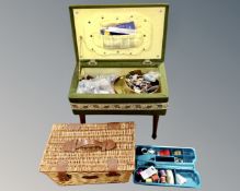 A 20th century sewing box on legs containing sewing items,