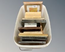 A create containing twenty five small photo frames, different styles and sizes,