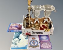 A box of tin wall signs, pair of glass hurricane lamps on stands, barbola type table lamp,