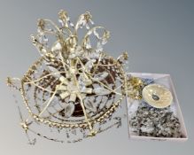 A vintage brass light fitting with brass drops