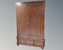 A Willis and Gambier double door wardrobe fitted with three drawers,
