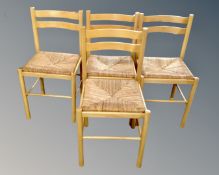 A set of four rush seated kitchen chairs.