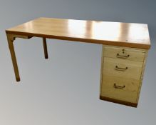 A 20th century Scandinavian single pedestal desk in a teak finish.