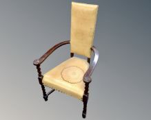 A 20th century barleytwist armchair upholstered in tan leather.