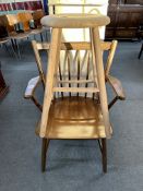 A beech spindle back open armchair together with a pine stool.