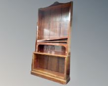 A set of antique mahogany open bookshelves.