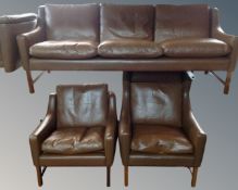 A 20th century Scandinavian three piece lounge suite upholstered in brown leather.
