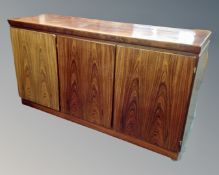 A Danish Skovby triple door sideboard in a rosewood finish.