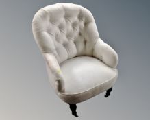A 19th century armchair re-upholstered in a white button back fabric.