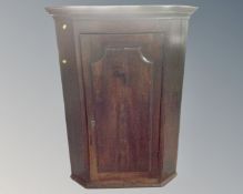 A Georgian oak panel door hanging corner cabinet.